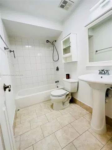 a bathroom with a toilet sink and shower