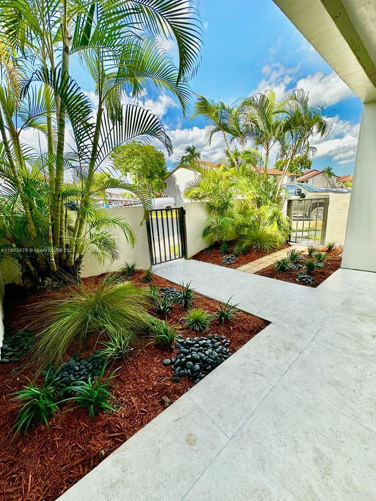 13440 Southwest 62nd Street, Unit G101 Miami, FL 33183 - Photo 20 of 23 a view of a back yard of the house
