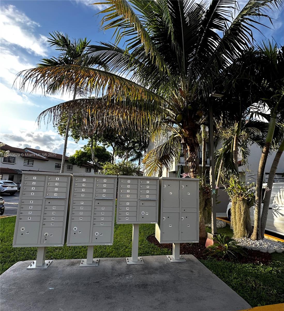 13440 Southwest 62nd Street, Unit G101 Miami, FL 33183 - Photo 22 of 23 a view of a palm trees front of house with wooden fence