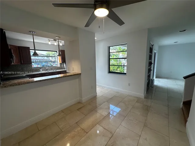 a view of entryway and kitchen