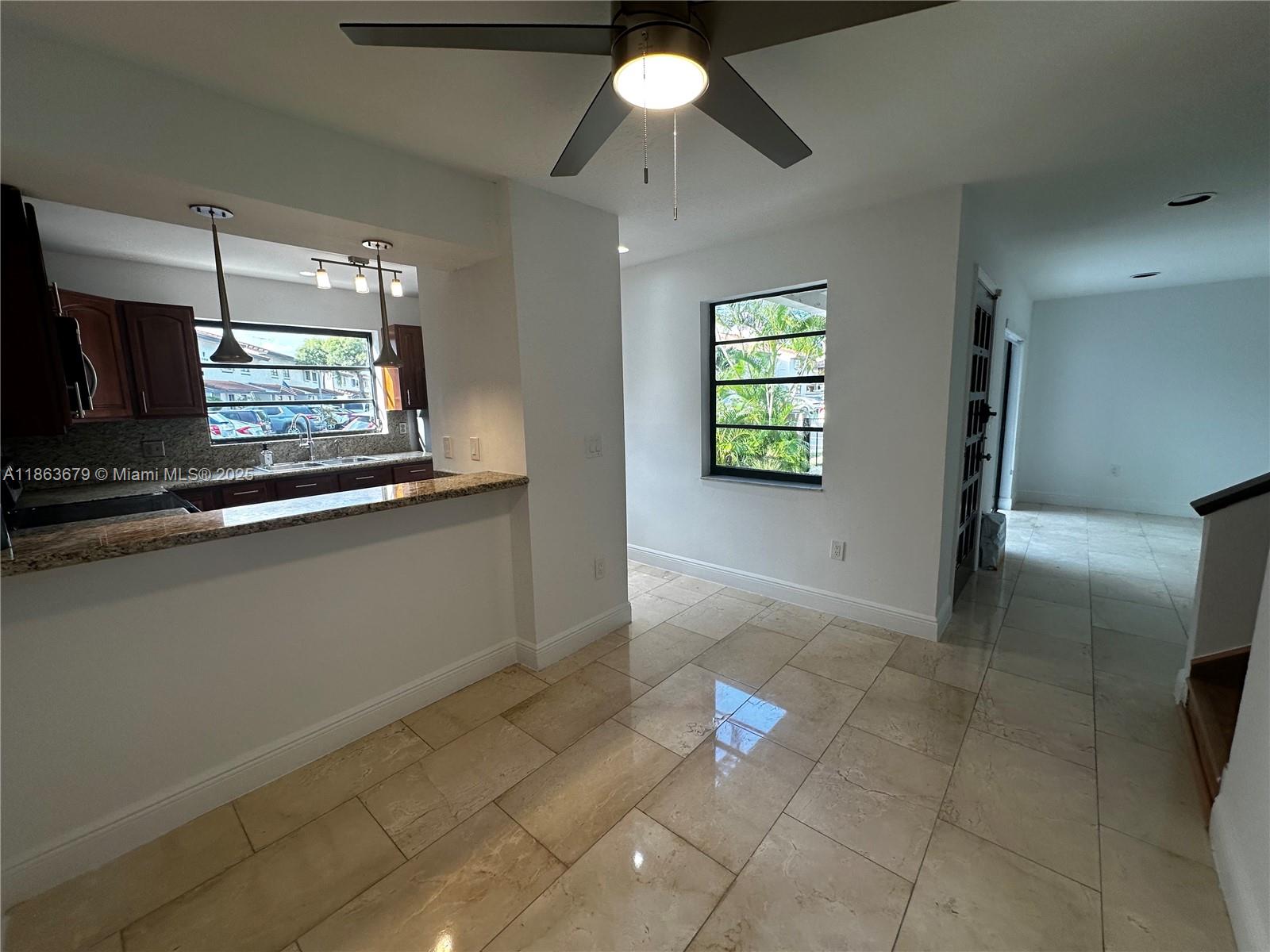 13440 Southwest 62nd Street, Unit G101 Miami, FL 33183 - Photo 4 of 23 a view of entryway and kitchen