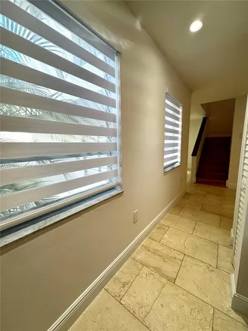 a view of a livingroom with an empty space and a window