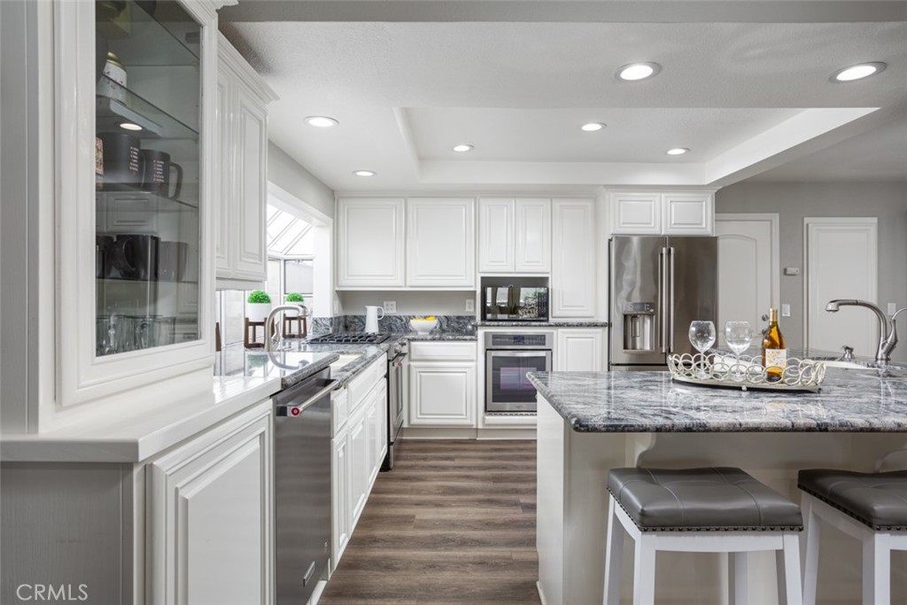 2789 Waxwing Circle Costa Mesa, CA 92626 - Photo 10 of 47 a kitchen with kitchen island granite countertop stainless steel appliances and sink