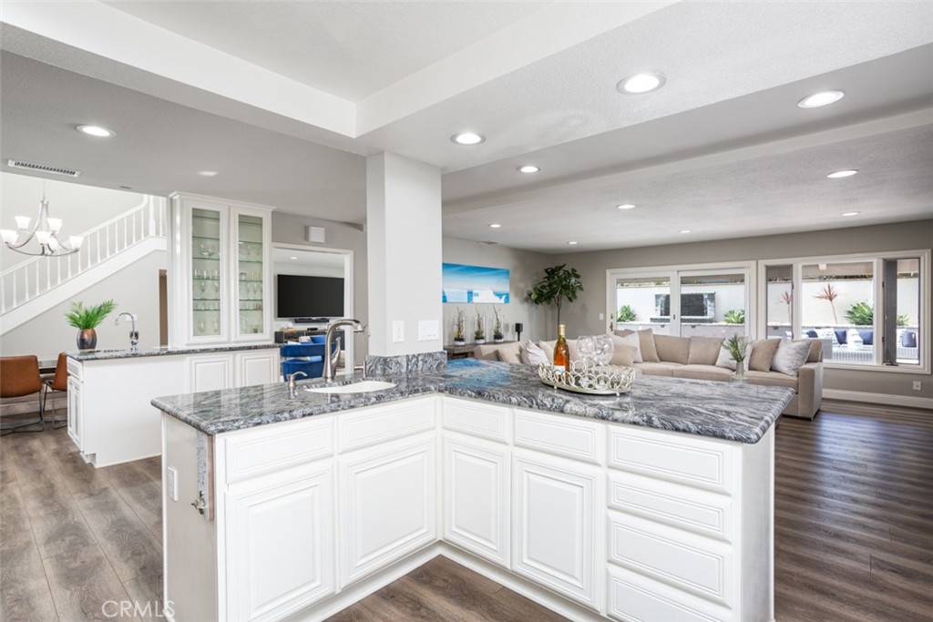 2789 Waxwing Circle Costa Mesa, CA 92626 - Photo 13 of 47 a kitchen with granite countertop kitchen island a sink and a stove with wooden floor