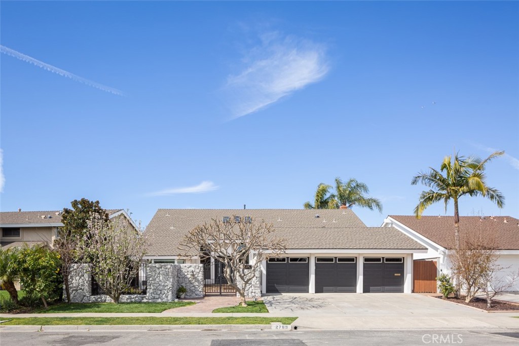 2789 Waxwing Circle Costa Mesa, CA 92626 - Photo 2 of 47 a view of a big house with a yard and potted plants