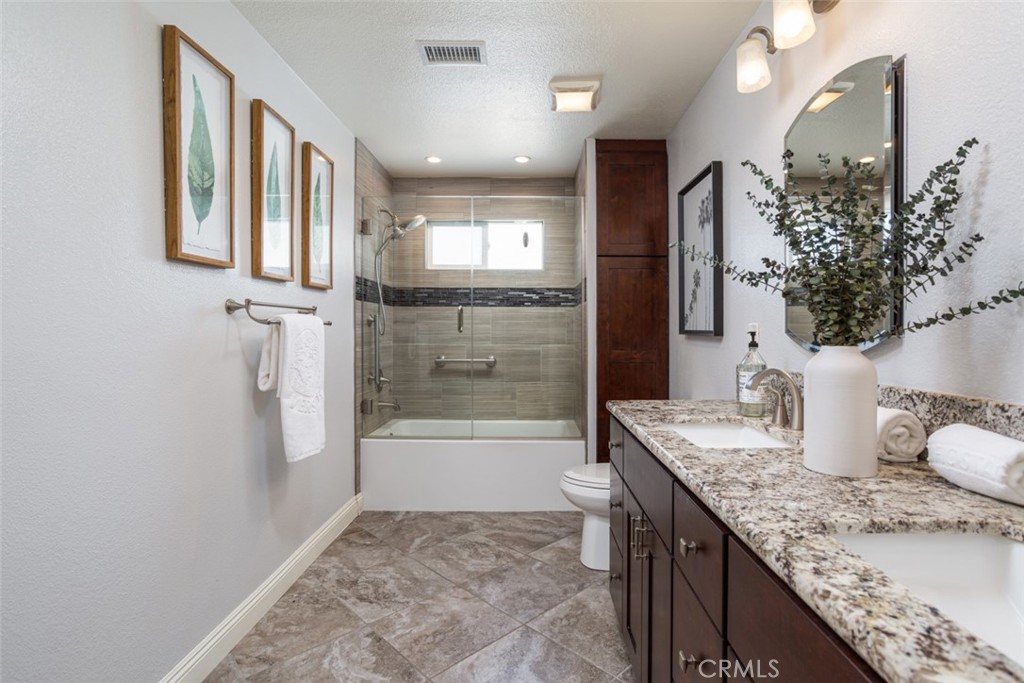 2789 Waxwing Circle Costa Mesa, CA 92626 - Photo 22 of 47 a bathroom with a granite countertop sink a toilet and shower