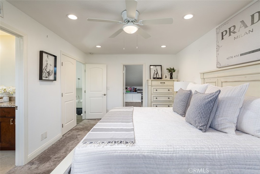 2789 Waxwing Circle Costa Mesa, CA 92626 - Photo 26 of 47 a spacious bedroom with a bed and a chandelier