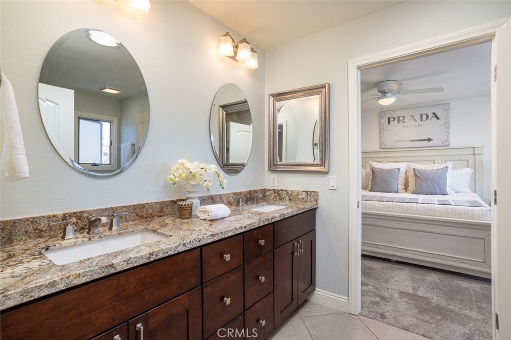 2789 Waxwing Circle Costa Mesa, CA 92626 - Photo 29 of 47 a bathroom with a granite countertop double vanity sinks and a mirror
