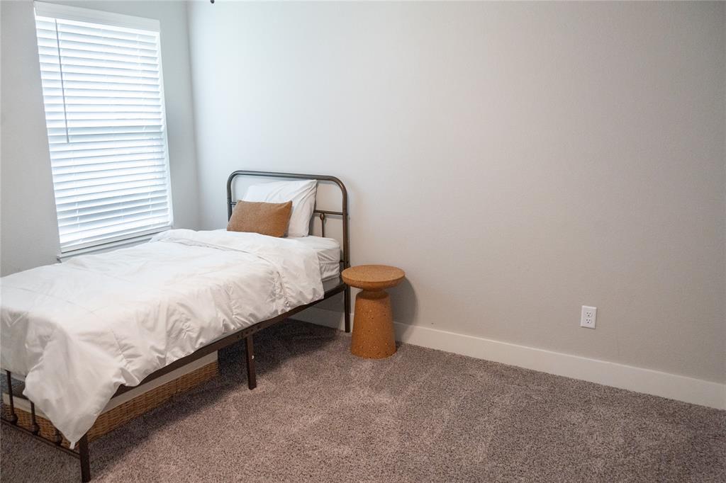 7909 Townsend Drive Waco, TX 76708 - Photo 17 of 22 Carpeted room with a window featuring white blinds, neutral wall paint, and white baseboards