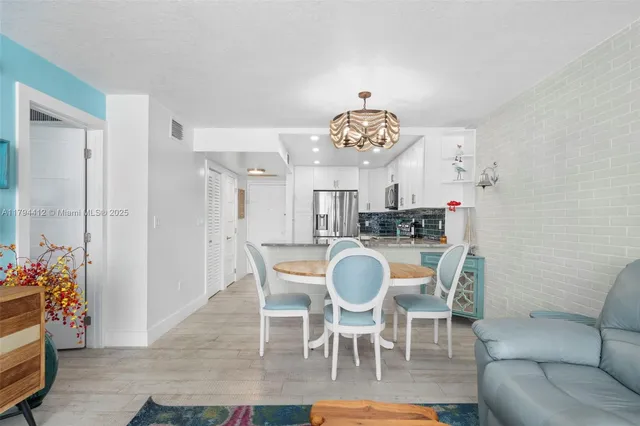 a view of a dining room with furniture and chandelier