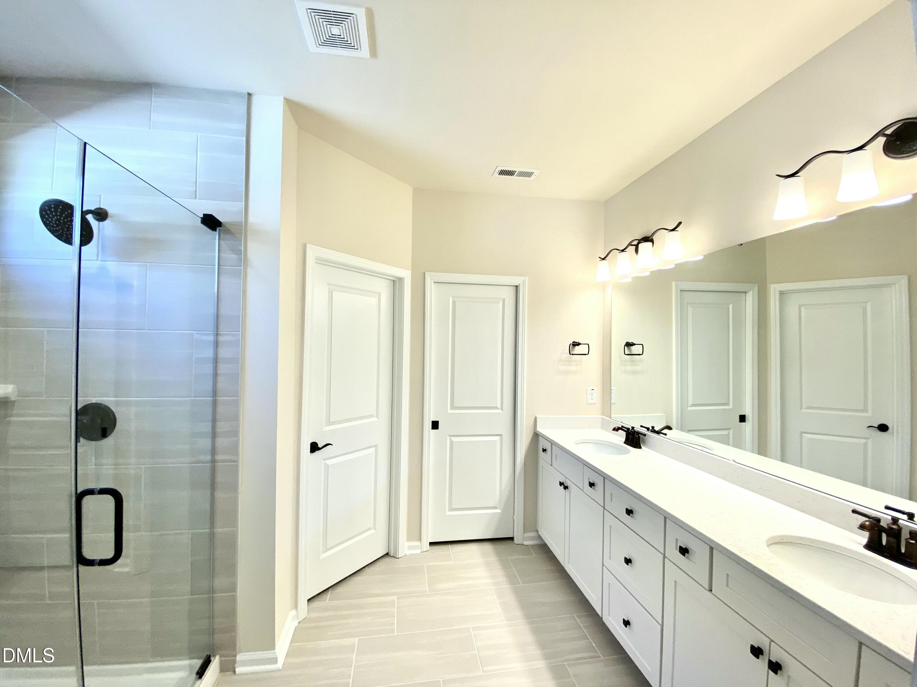 2313 Hedge Maple Drive Raleigh, NC 27603 - Photo 12 of 32 a spacious bathroom with a double vanity sink mirror and shower