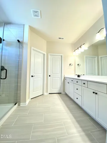a bathroom with a tub and shower