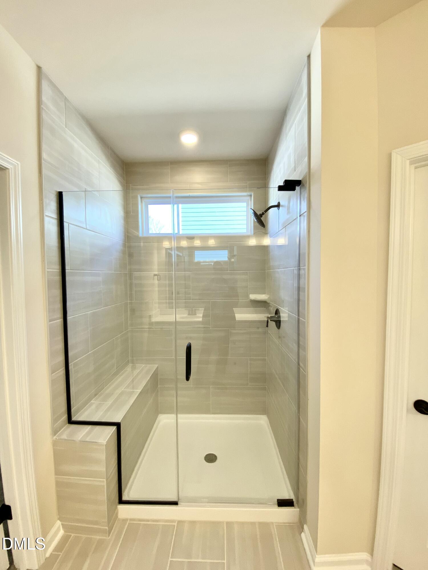 2313 Hedge Maple Drive Raleigh, NC 27603 - Photo 14 of 32 a bathroom with a tub and shower