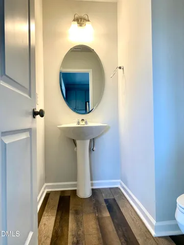 a view of a living room with hardwood floor and a ceiling fan