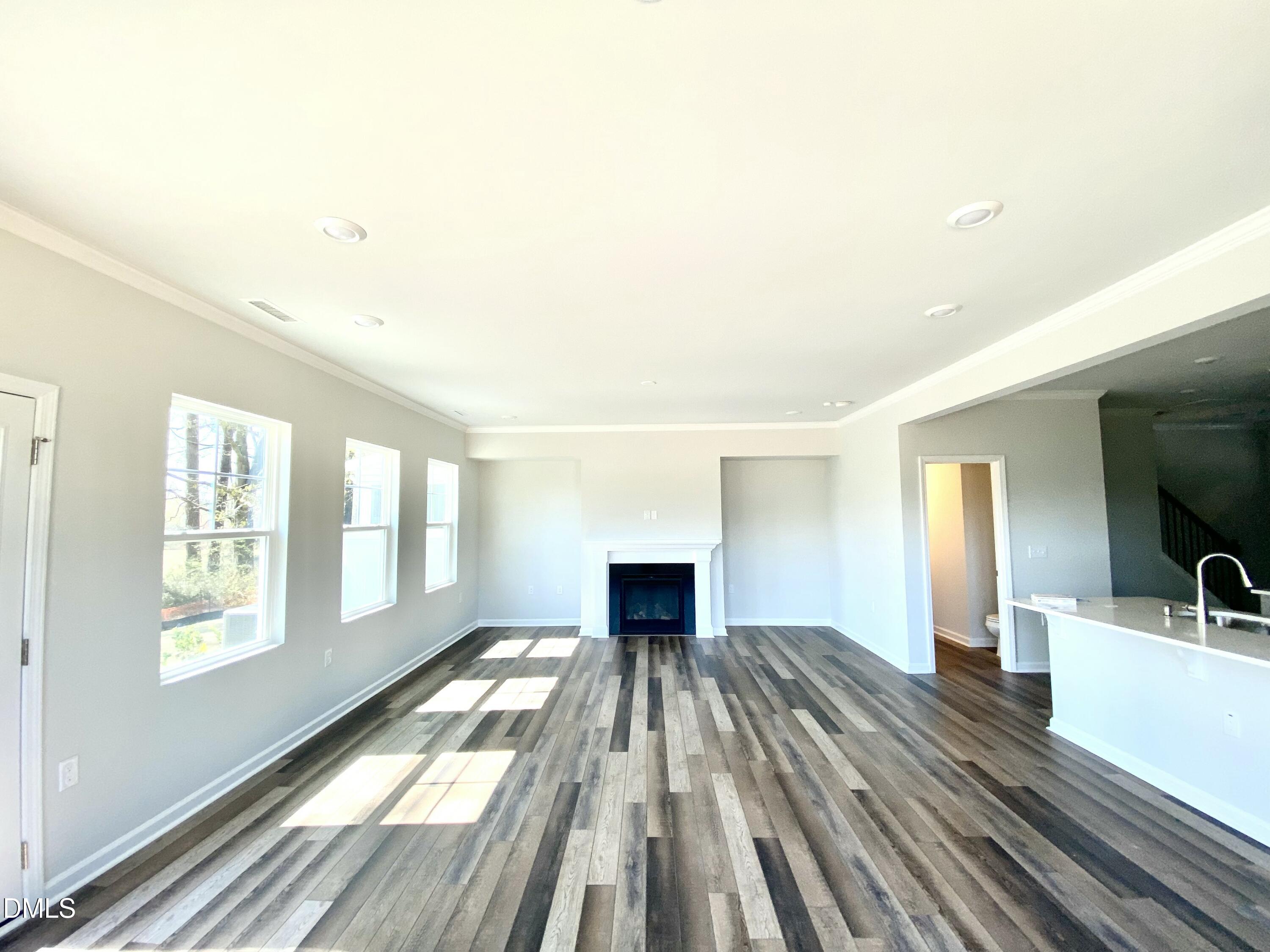 2313 Hedge Maple Drive Raleigh, NC 27603 - Photo 26 of 32 a view of a living room with hardwood floor and a ceiling fan