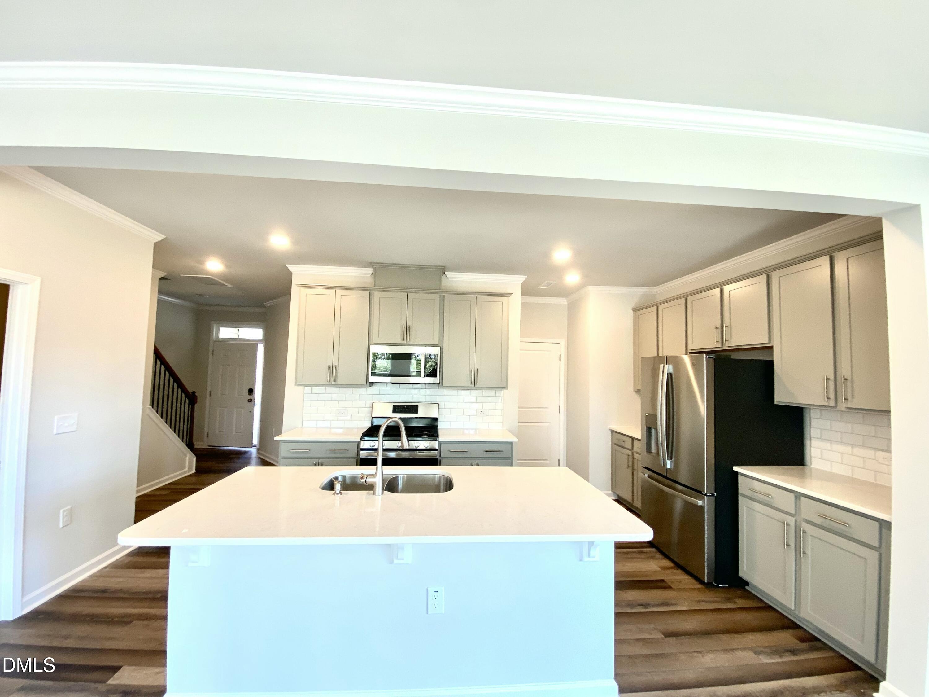 2313 Hedge Maple Drive Raleigh, NC 27603 - Photo 8 of 32 a kitchen with stainless steel appliances a refrigerator sink and microwave