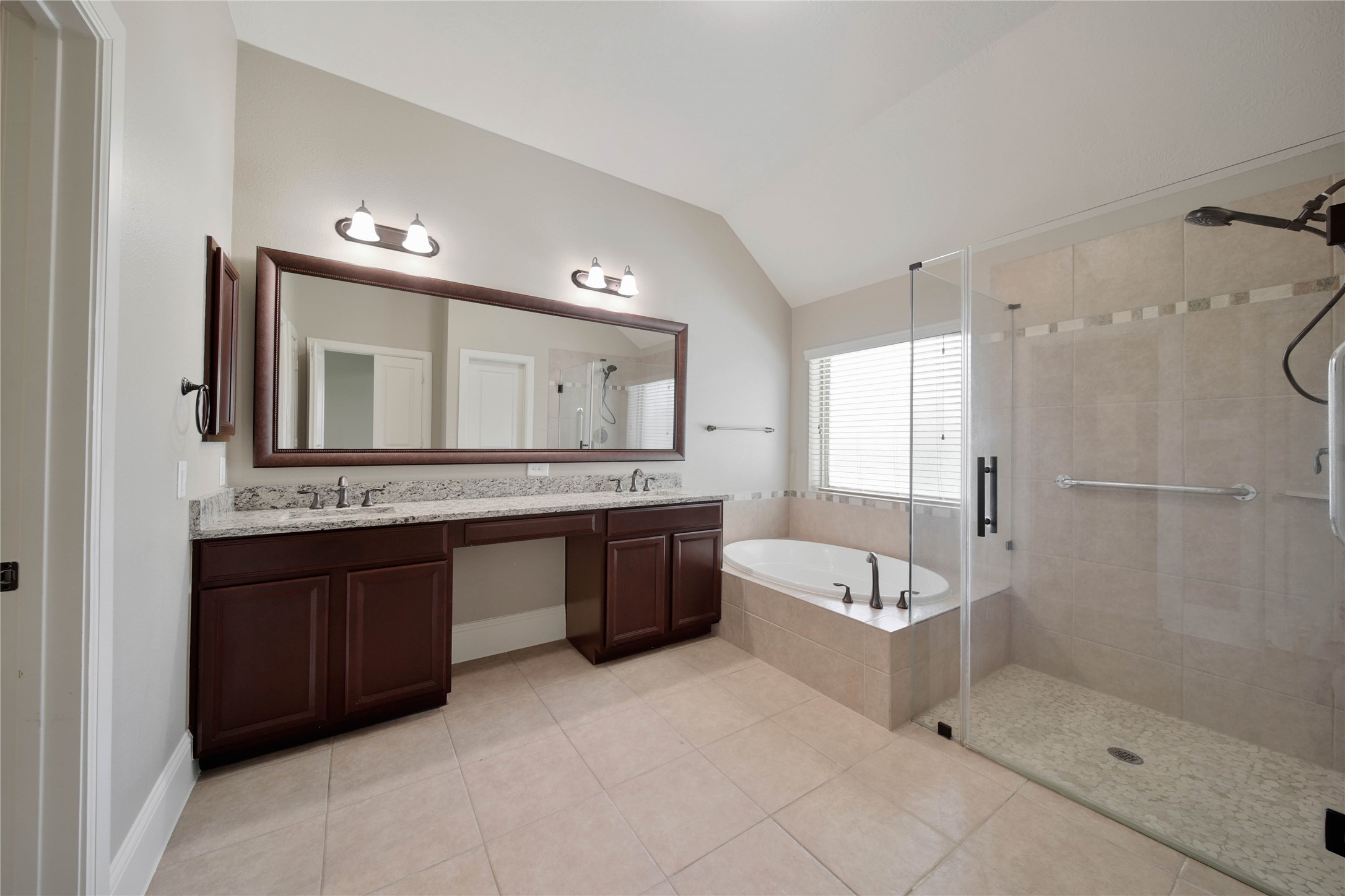 1215 Jake Springs Court Spring, TX 77386 - Photo 18 of 49 You'll love the spa-like bath with dual sinks, a walk-in glass shower, and soaking tub.