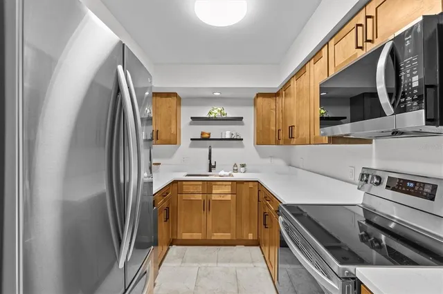 a kitchen with stainless steel appliances a sink and a stove