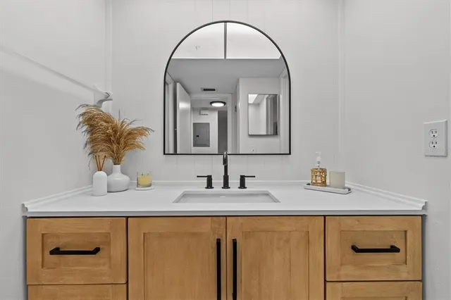 a bathroom with a double vanity sink and a mirror