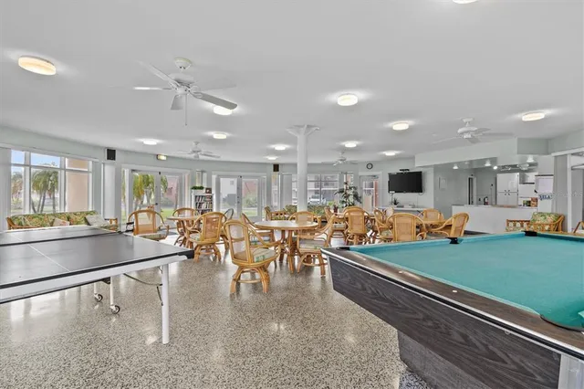 a group of people sitting on a floor in a room