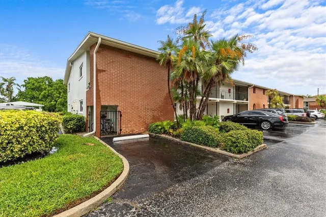 a front view of a house with a yard and plant