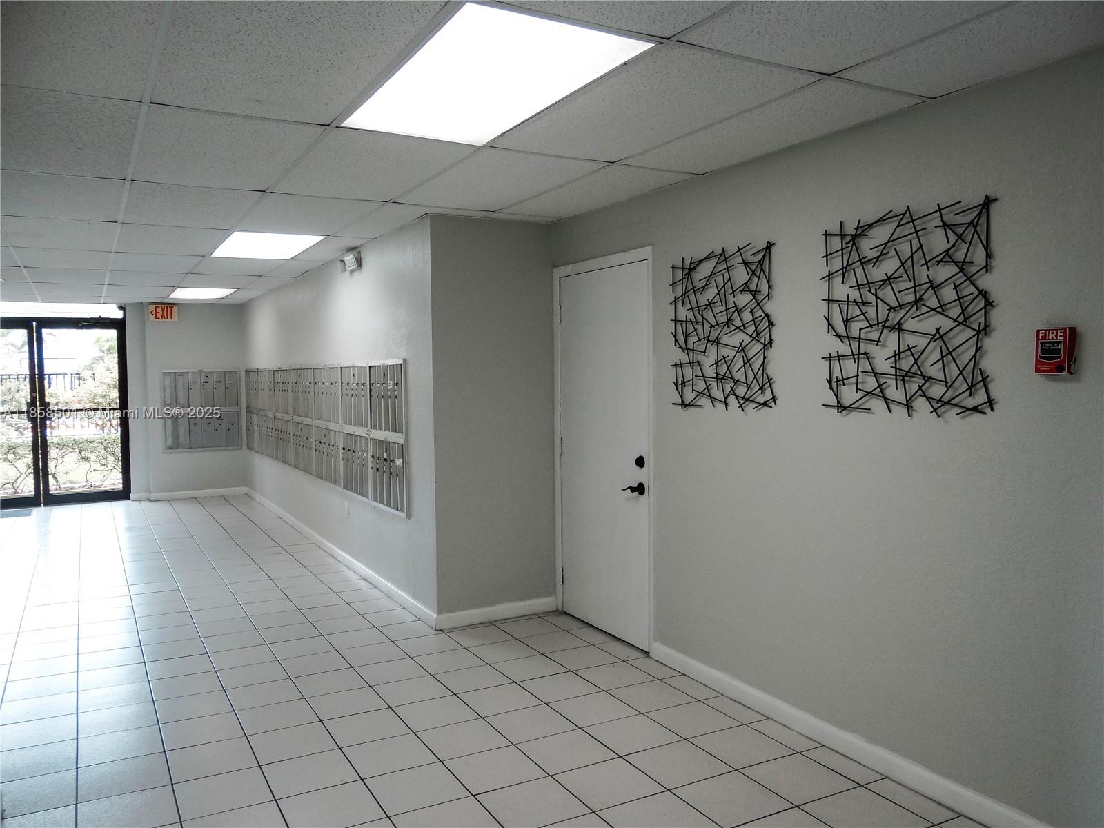1800 West 54th Street, Unit 309 Hialeah, FL 33012 - Photo 15 of 19 an empty room with windows