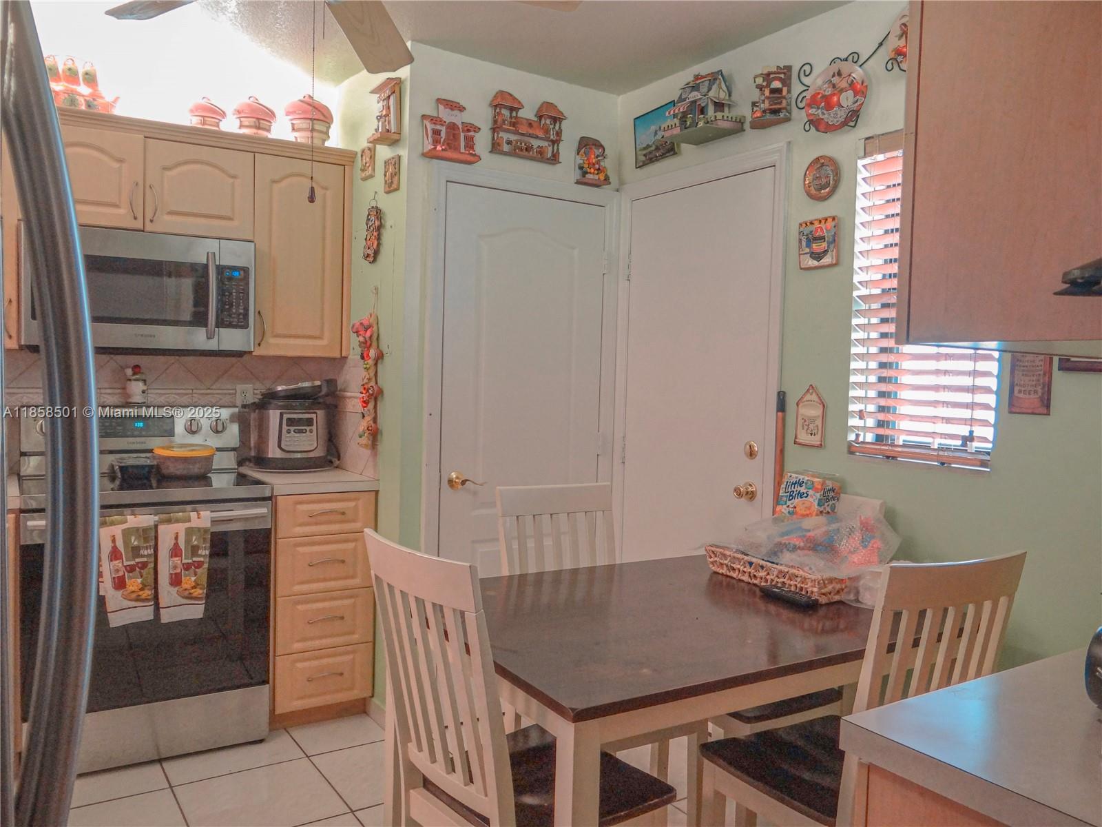 1800 West 54th Street, Unit 309 Hialeah, FL 33012 - Photo 6 of 19 a kitchen with stainless steel appliances granite countertop a refrigerator and a stove top oven