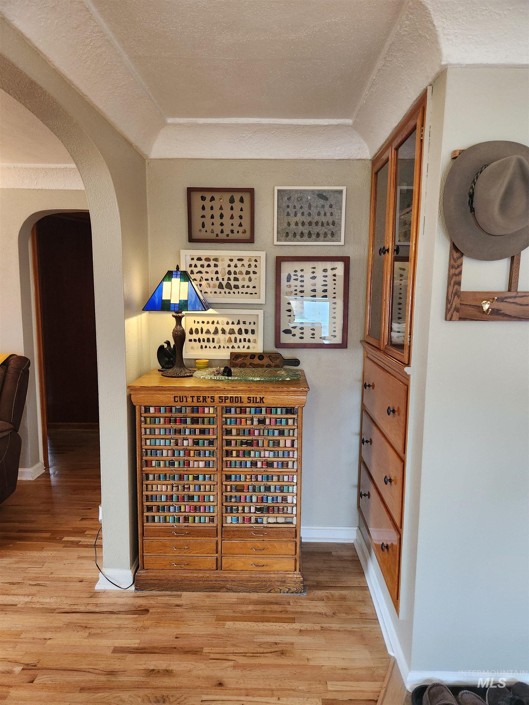 1105 Nevada Street Gooding, ID 83330 - Photo 13 of 26 area with a textured ceiling, arched walkways, and light wood-style flooring