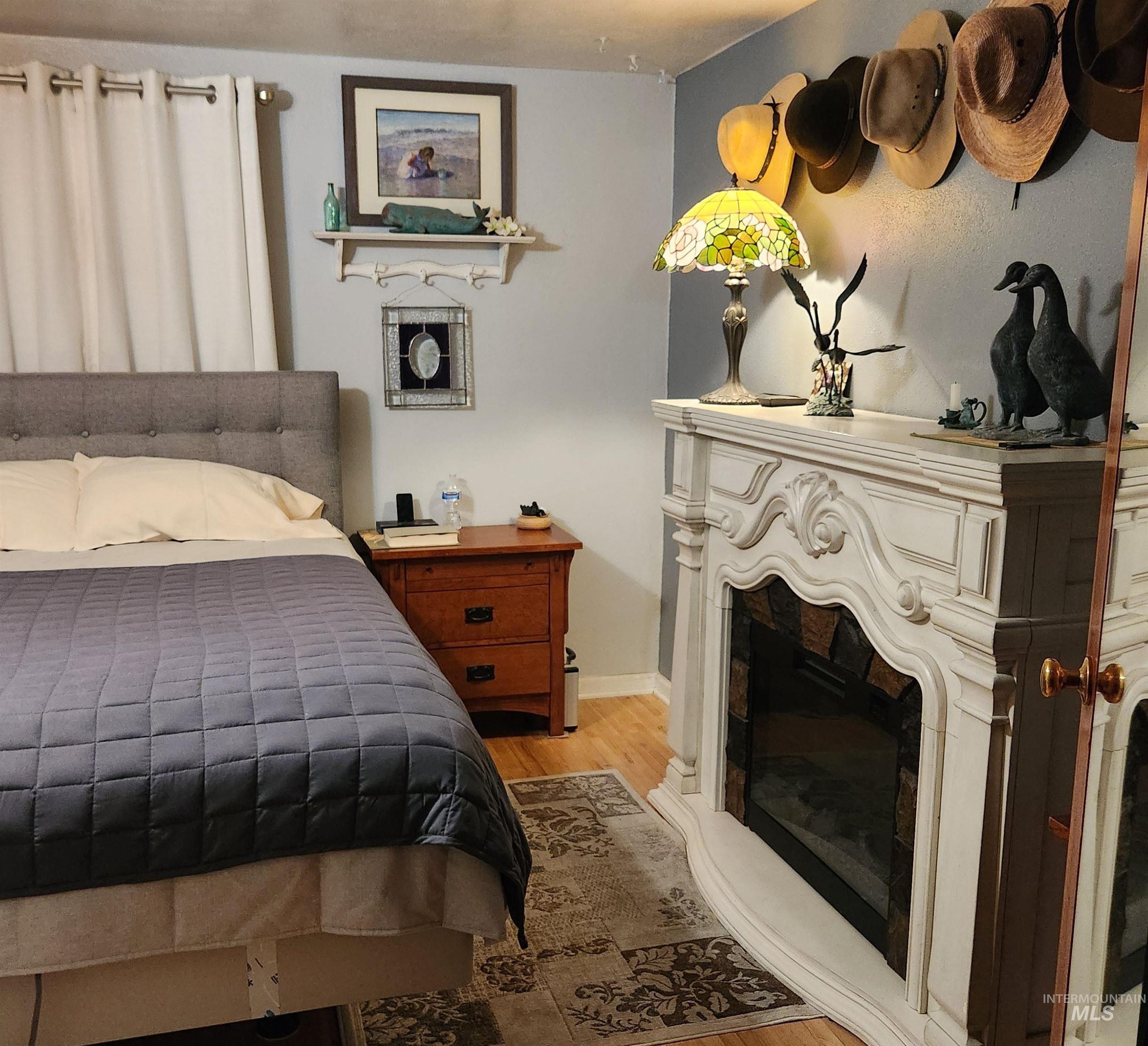 1105 Nevada Street Gooding, ID 83330 - Photo 17 of 26 Bedroom featuring light wood-style flooring and a fireplace