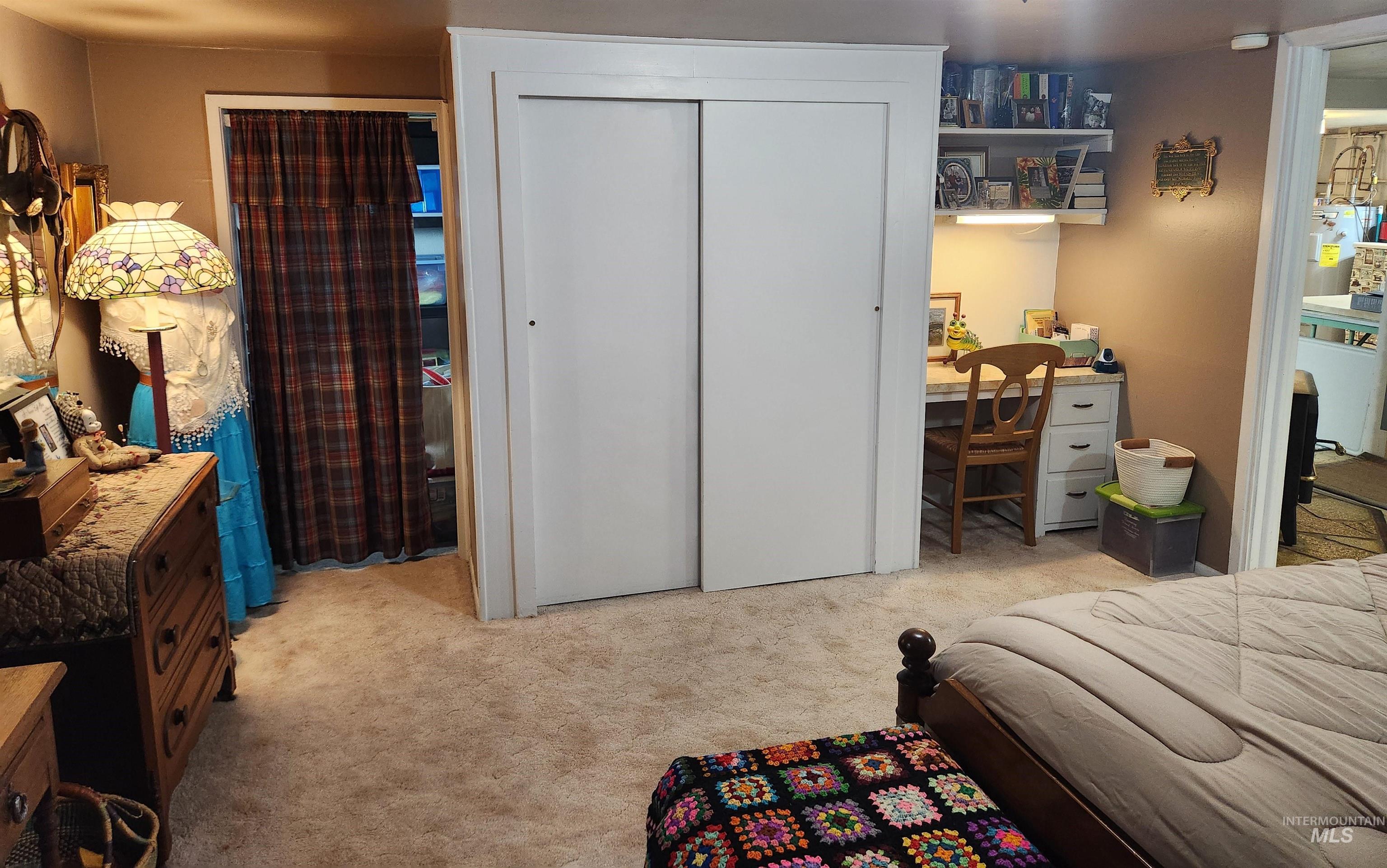 1105 Nevada Street Gooding, ID 83330 - Photo 19 of 26 Bedroom with an office area, light carpet, a closet, and water heater