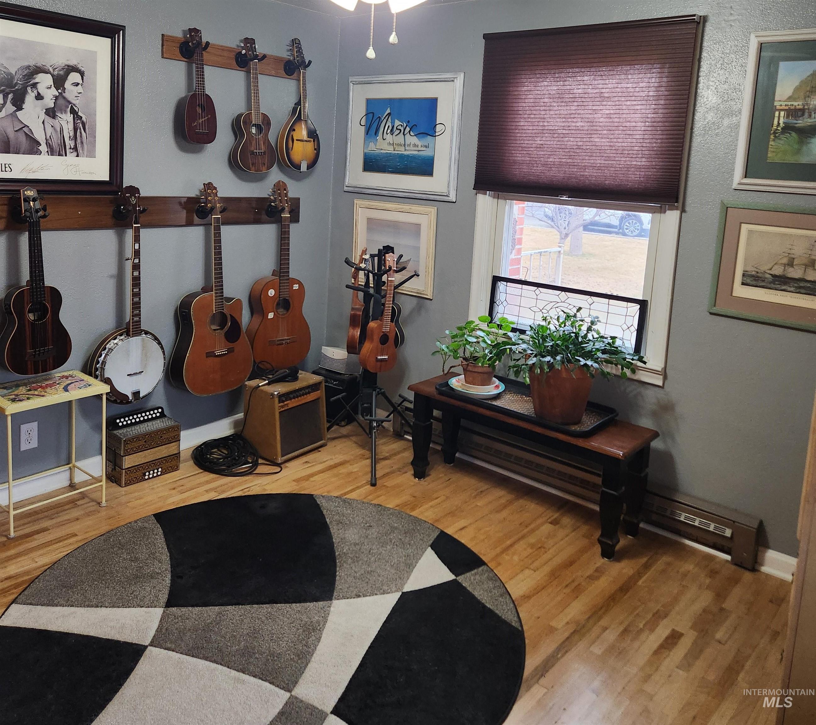 1105 Nevada Street Gooding, ID 83330 - Photo 22 of 26 Interior space featuring a baseboard radiator, light wood finished floors, and a ceiling fan