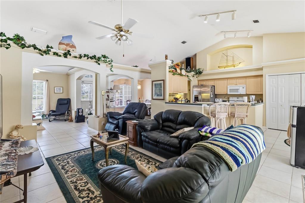 3225 Canoe Creek Road St. Cloud, FL 34772 - Photo 9 of 30 a living room with furniture flowers and a chandelier