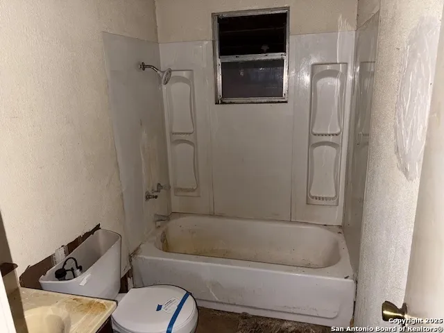 a bathroom with a toilet and a bathtub