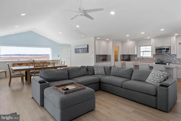 a kitchen with kitchen island granite countertop wooden cabinets and white appliances