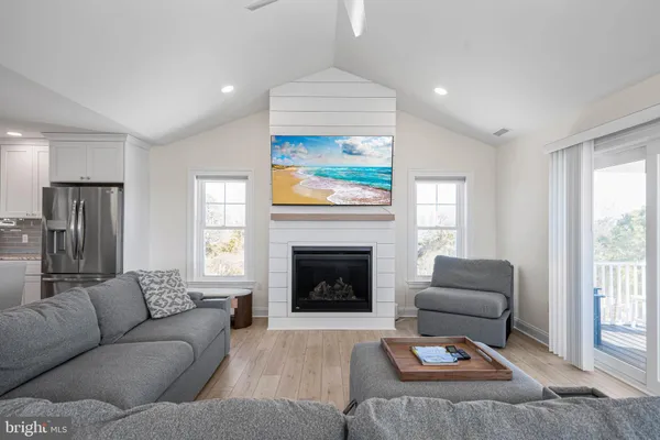 a living room with furniture fireplace and flat screen tv