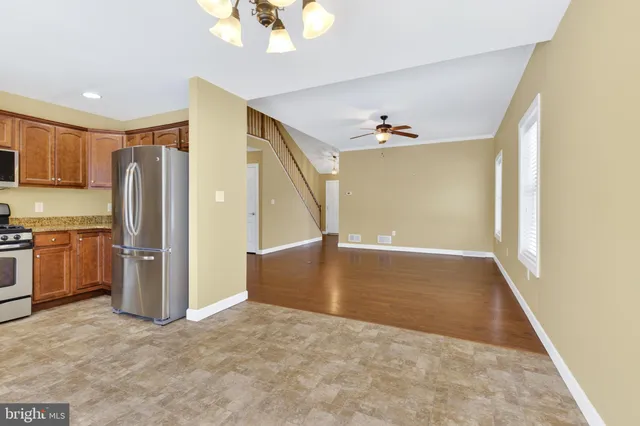 a view of a kitchen with a sink and refrigerator