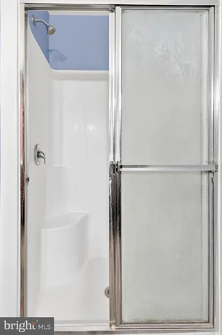 a bathroom with a glass shower door