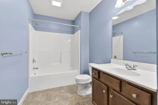 a bathroom with a sink a toilet and a large mirror