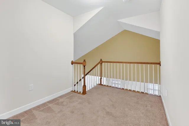 an empty room with closet and mirror