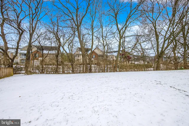 a view of yard covered with snow in front of house