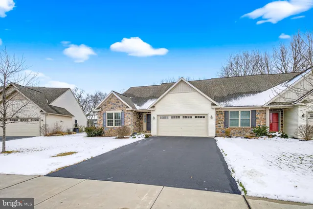 a view of a white house with a yard
