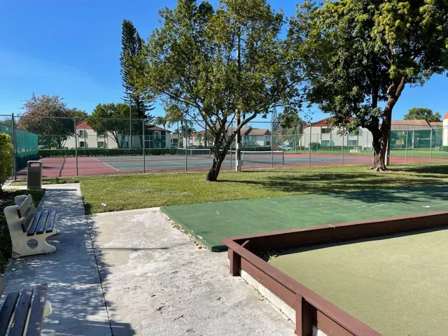 a view of a backyard with a garden and trees