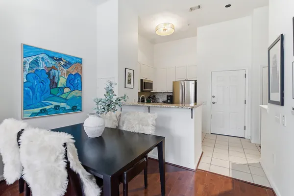 a dining room with furniture and wooden floor