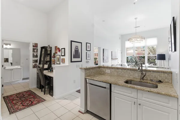 a kitchen with stainless steel appliances granite countertop a sink counter space cabinets and a window