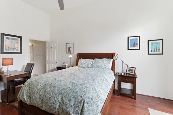 a bedroom with a bed and a chair