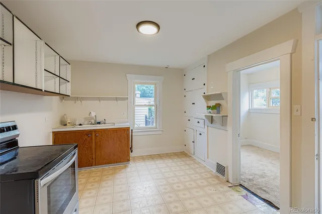 a kitchen with cabinets and window