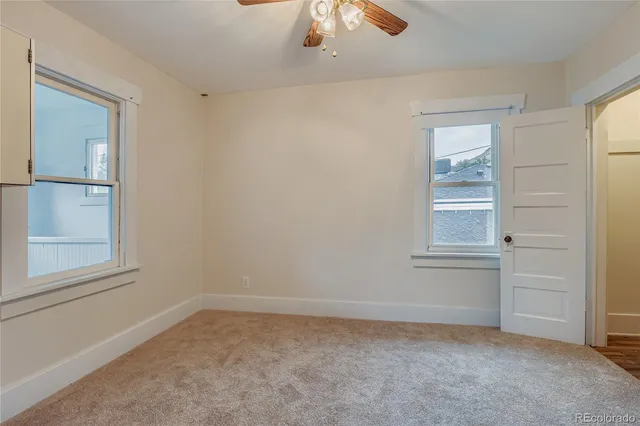 an empty room with windows and closet