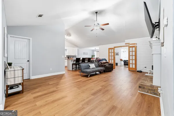 a living room with furniture and a wooden floor