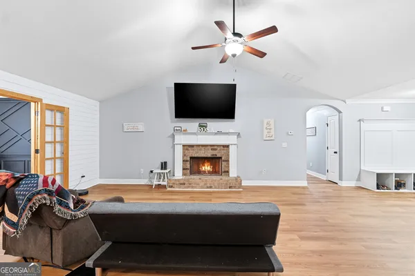 a living room with furniture a fireplace and a flat screen tv