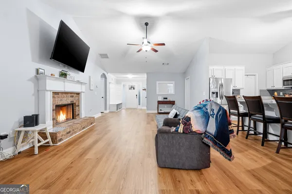 a living room with furniture fireplace and flat screen tv
